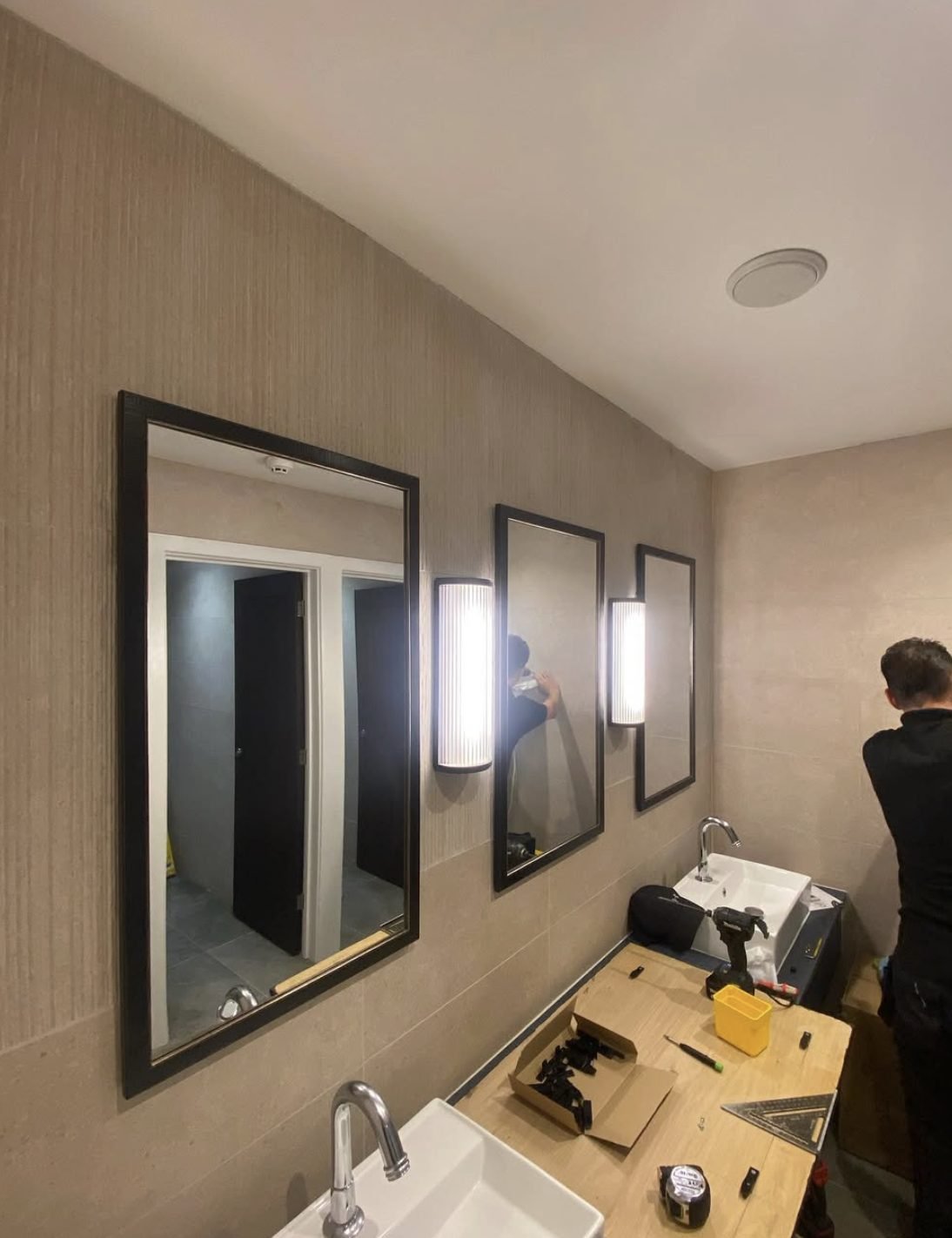 Commercial bathroom lighting and mirror installation