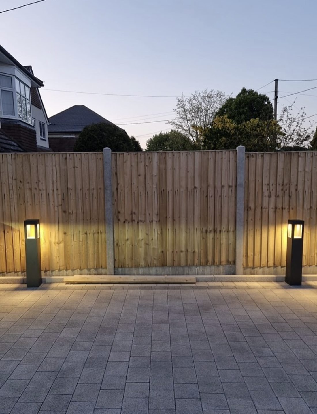 Garden bollard lighting installed on a block paved patio